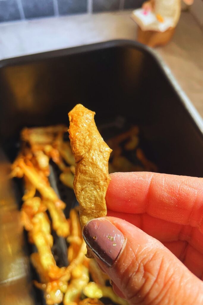 Freshly prepared crispy golden air fryer potato skin fries