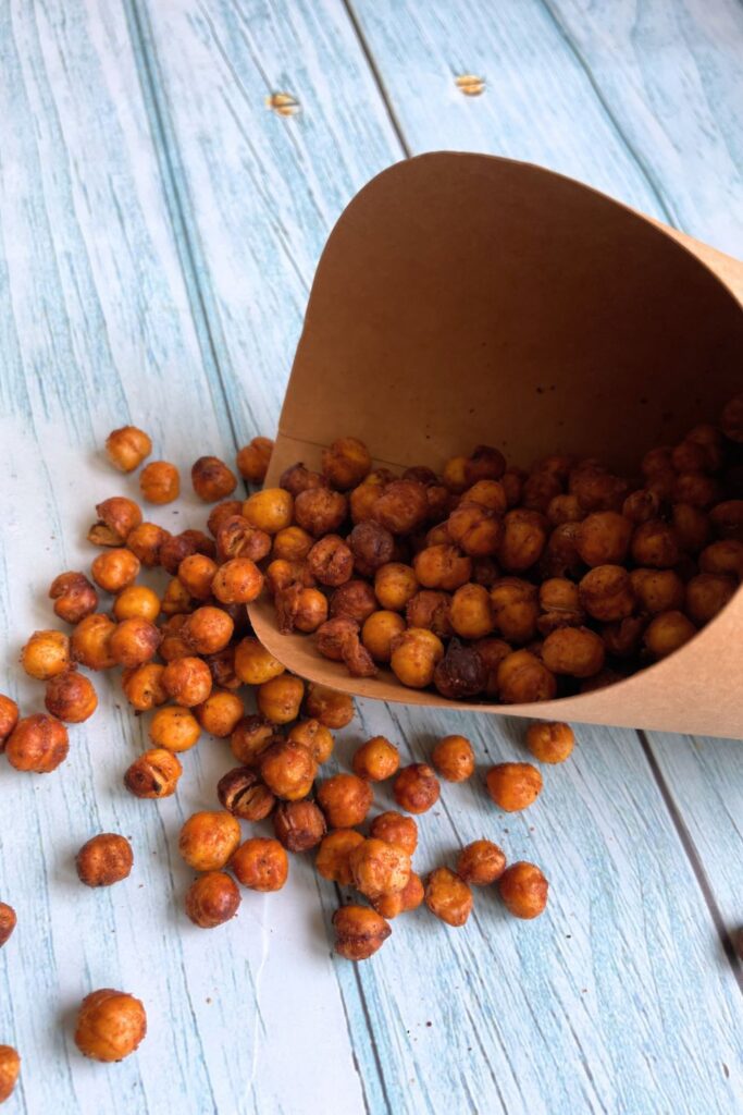 a paper cone with air fryer roasted chickpeas on it
