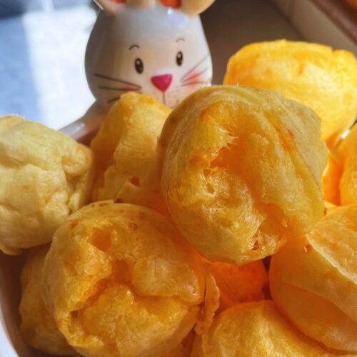 Freshly baked golden Brazilian Cheese Bread served in a bunny dish