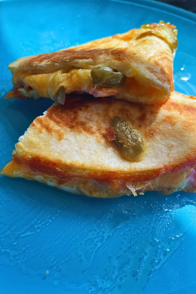 Breakfast Quesadillas cut into halves served in a blue plate