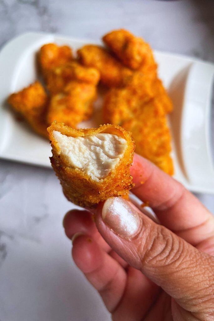 Close up shot of crispy air fryer chicken tender cooked from the inside