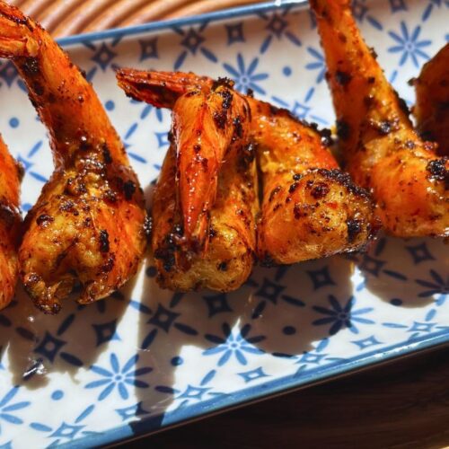 Grilled Tiger Prawns served on a blue-and-white patterned rectangular plate.