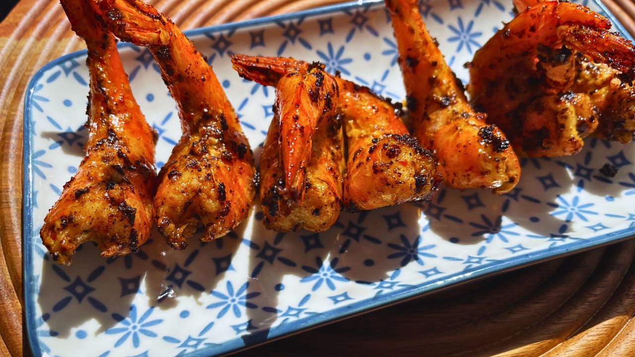 Grilled Tiger Prawns served on a blue-and-white patterned rectangular plate.