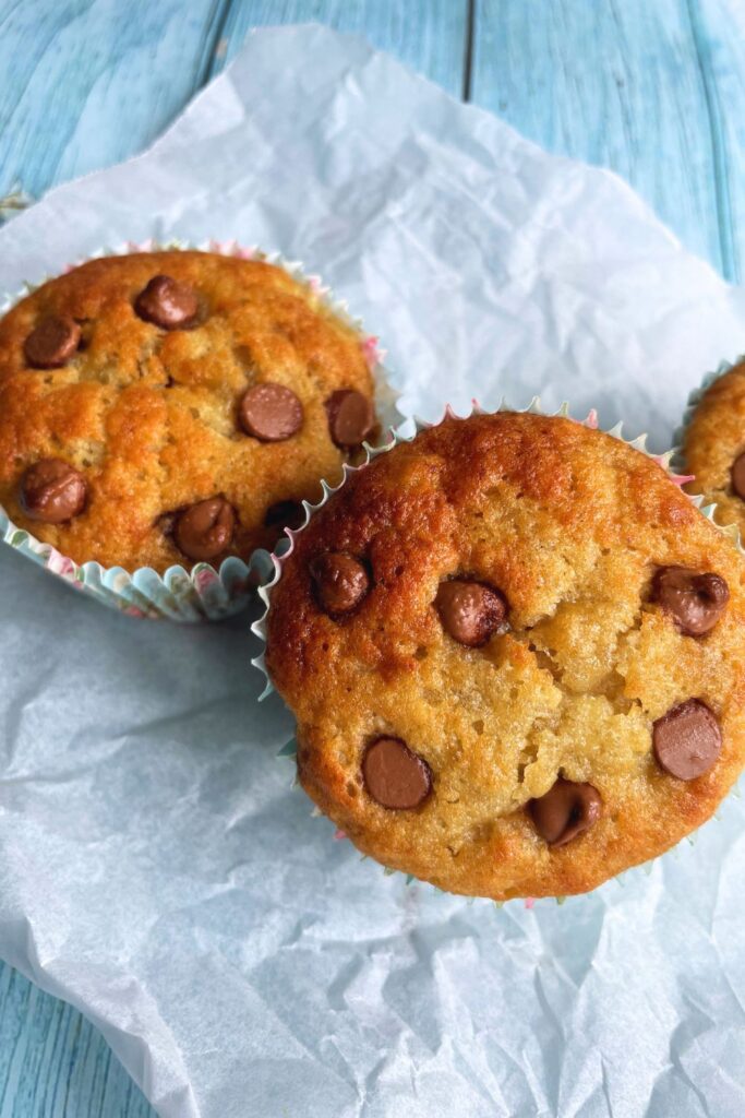 2 Banana Chocolate Chip Muffins on a parchment paper