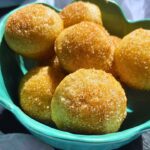 Freshly made golden crunchy top mini Cinnamon Sugar Donut Muffins served in a blue bowl