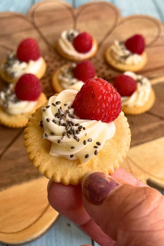 Close up shot of Raspberry & Cream Cheese on Crackers