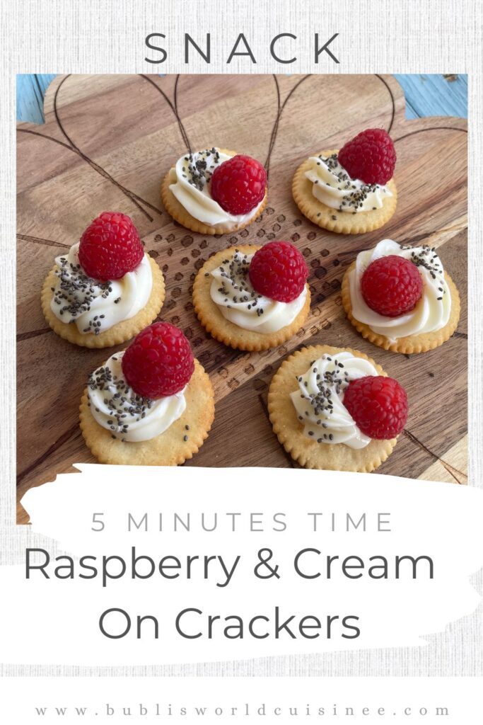 Party Appetisers Raspberry & Cream Cheese Crackers served on a wooden board