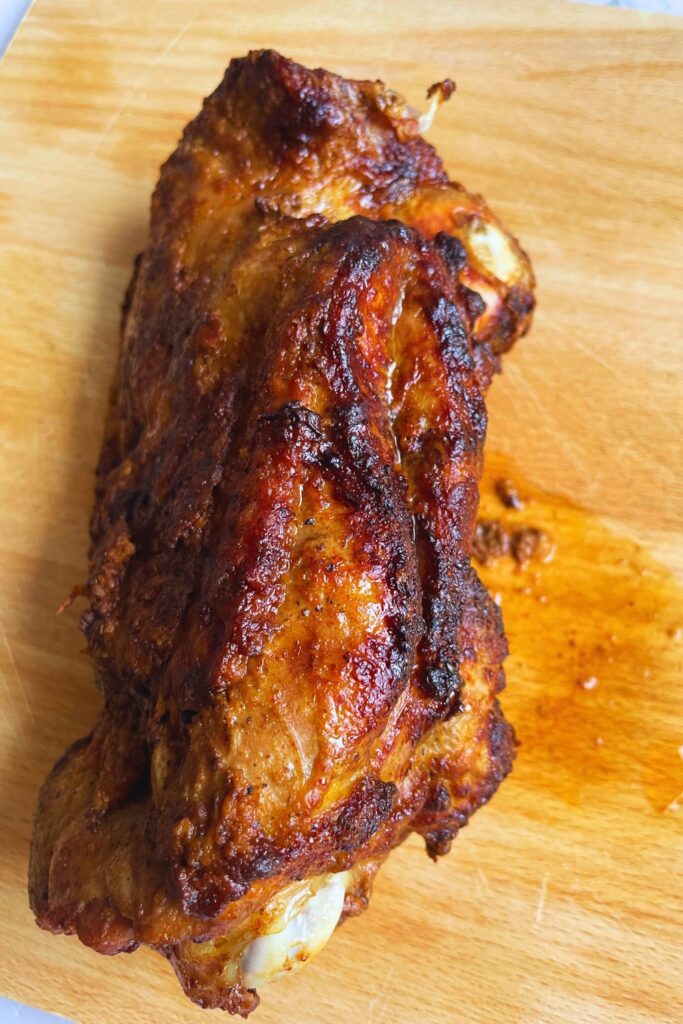 Turkey Thigh Roast done In Air Fryer and laid on a wooden board