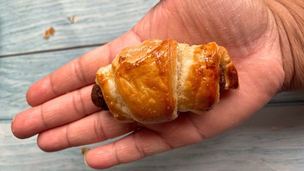 Close up shot of Mini Chocolate Croissants on a hand