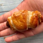 Close up shot of Mini Chocolate Croissants on a hand