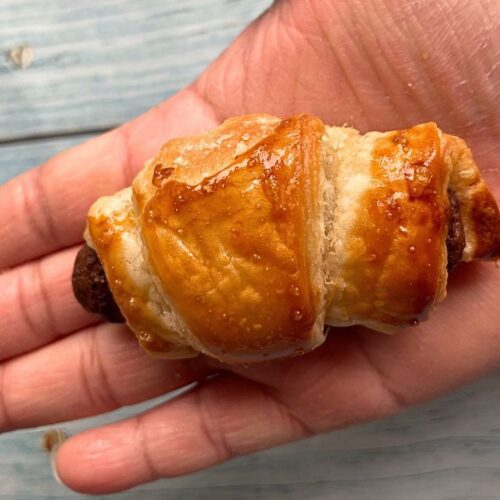 Close up shot of Mini Chocolate Croissants on a hand