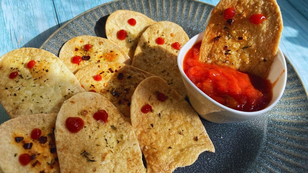 Halloween Ghost Chips With Tortilla served on a plate with some dipping sauce