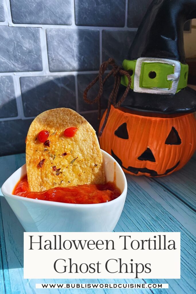 Halloween Ghost Chips With Tortilla displayed with dip and a halloween pumpkin