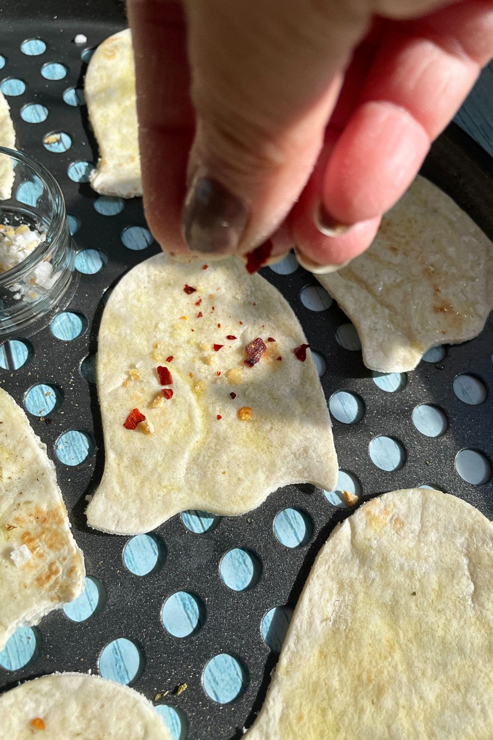 Sprinkle seasoning on the tortilla chips