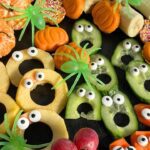 Halloween Fruit Platter with oranges, apples, carrots, grapes, cucumbers